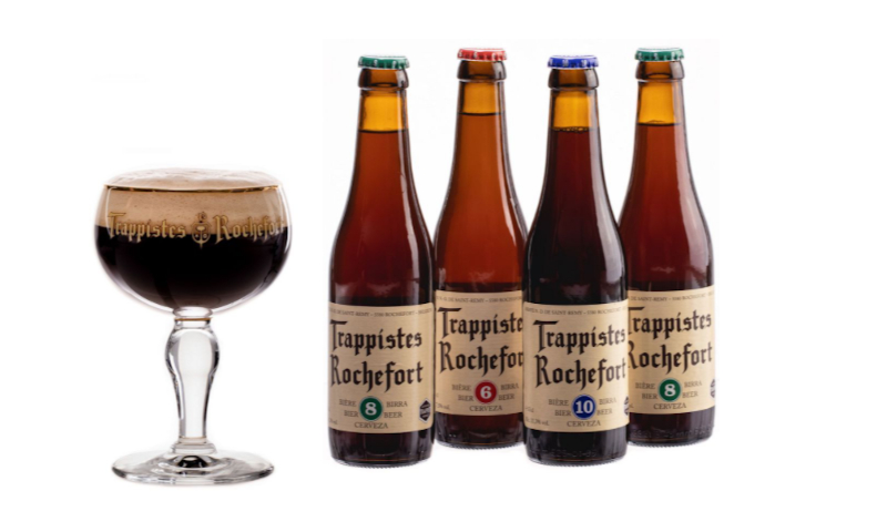 Trappist Rochefort kelk gevuld met bier met daarnaast 4 flesjes Rochefort bier